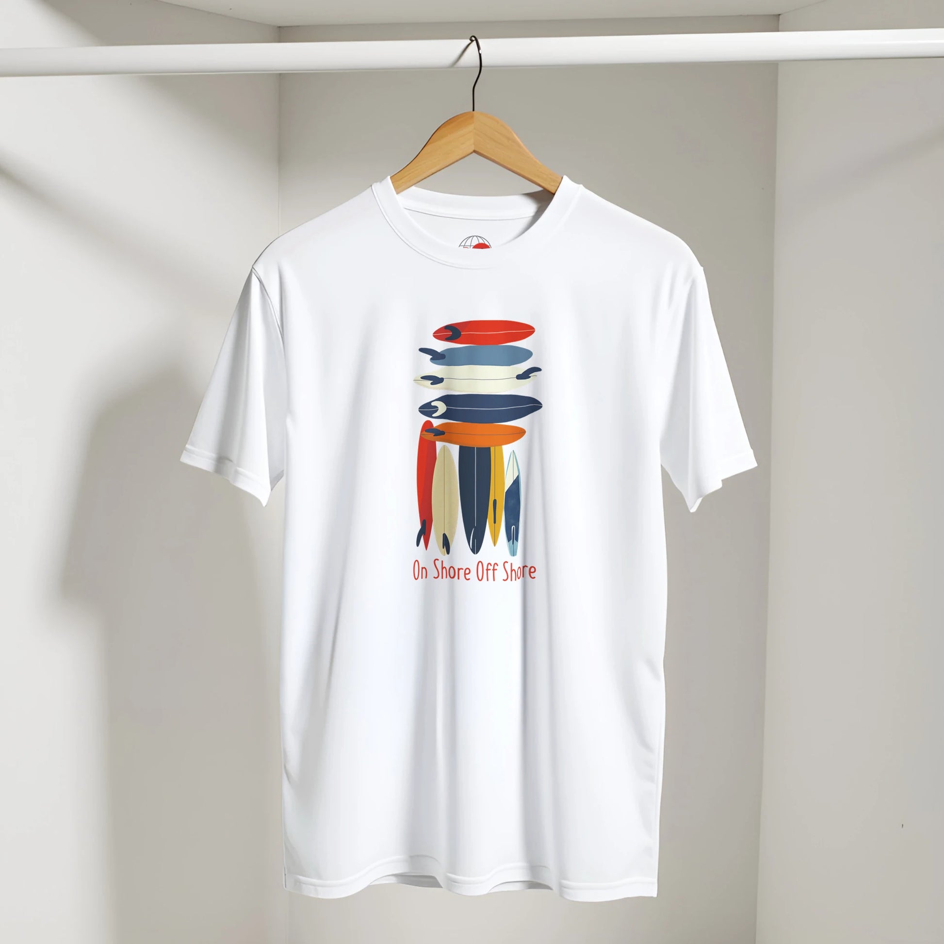 White t-shirt with colorful graphic design on a hanger against a plain background