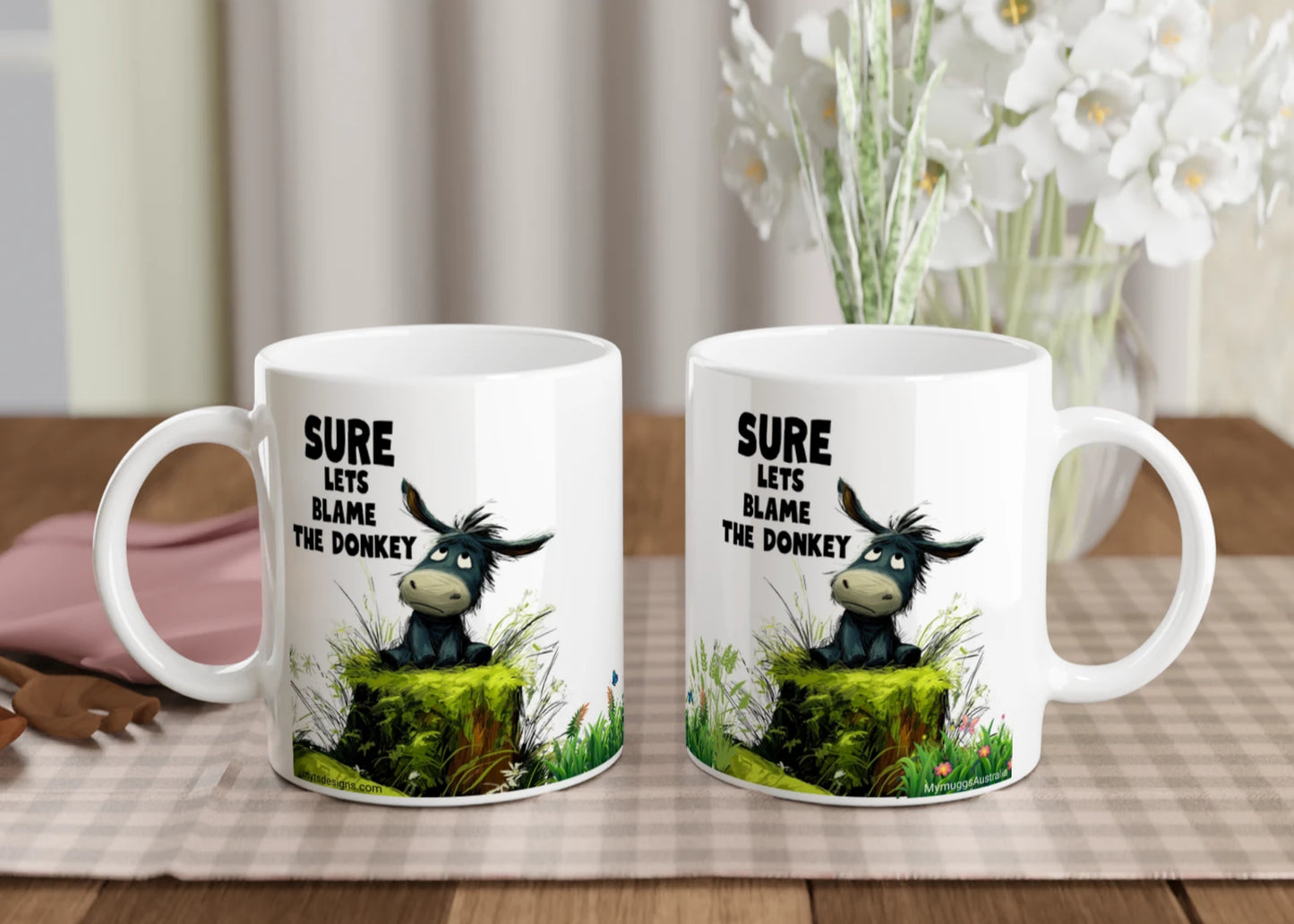 2 white ceramic coffee mugs sitting side by side, showing the the image from both sides