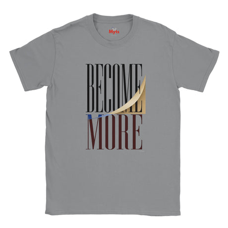 A sports gray short-sleeve crewneck T-shirt featuring a graphic print on the front with the words 'BECOME MORE' in black and dark brown block letters, overlaid with a peeled-back cream paper effect showing a gold highlight.