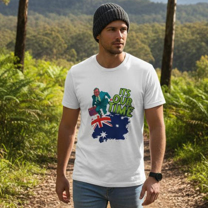 A man standing in an Australian bush path wearing a white t-shirt with a graphic design.