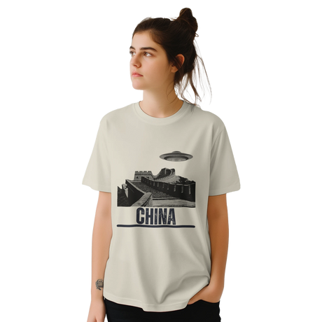 “Woman wearing a white T-shirt with a vintage black-and-white Great Wall of China illustration and a UFO hovering above it, labeled ‘CHINA,’ designed by MytsDesigns.com in a gym setting”

