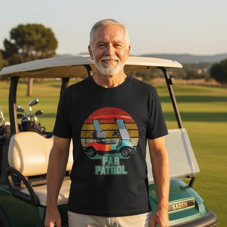 Man wearing a 'Par Patrol' t-shirt standing in front of a golf cart on a golf course.