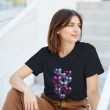 Woman wearing a black t-shirt with colorful heart design sitting outdoors.