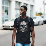 Man wearing a black t-shirt with a skull design on a street.