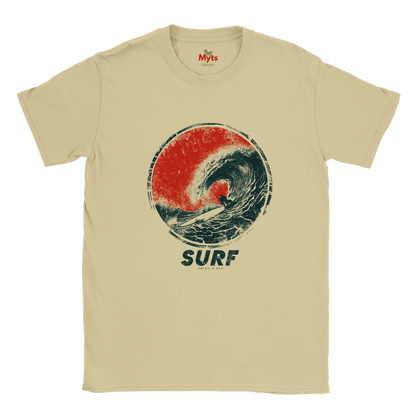 A Sand crewneck t-shirt featuring a distressed graphic of a surfer inside a red and dark blue wave, with the word 'SURF' printed below.