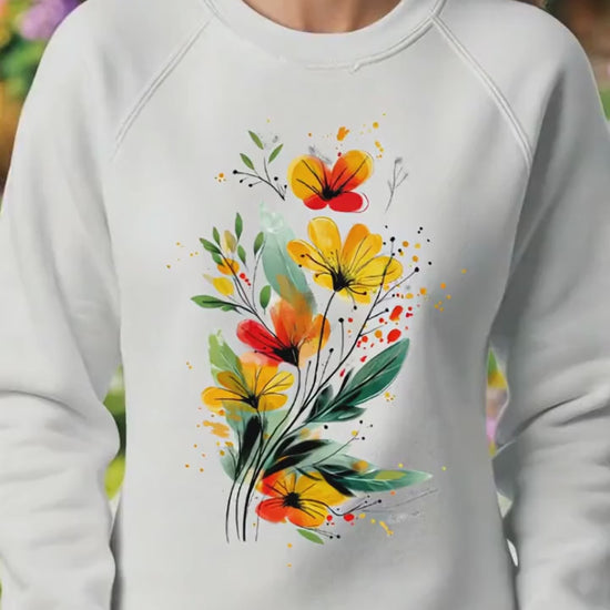 Video of a woman walking through a cottage garden wearing a white floral sweatshirt