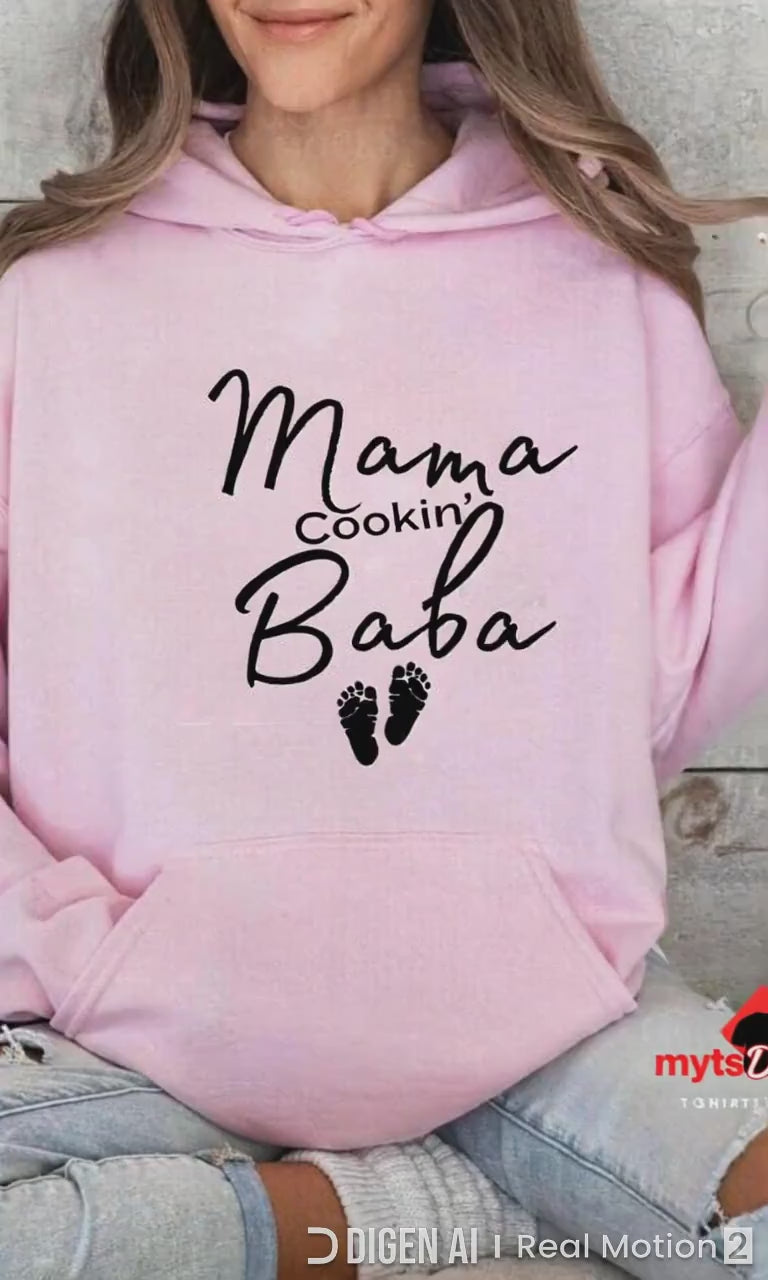 Girl in Pink Hoodie "Mama Cookin' Baba" sittin on a couch