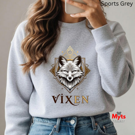 Person wearing a gray sweatshirt with a fox design and 'Vixen' text, holding a phone.