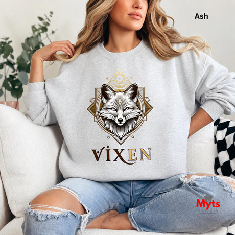 Person wearing an Ash sweatshirt with a fox design and 'Vixen' text, sitting on a couch.